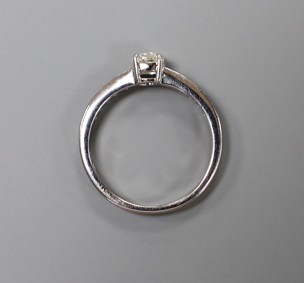 A modern platinum and single stone diamond ring, with diamond set shoulders, size M, gross weight 3.7 grams